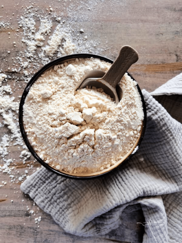 Homemade Bisquick and a scoop in a wood bowl.