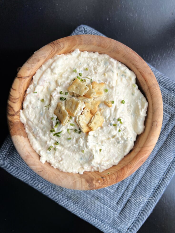 Chicken in a Biskit dip in a wood bowl.