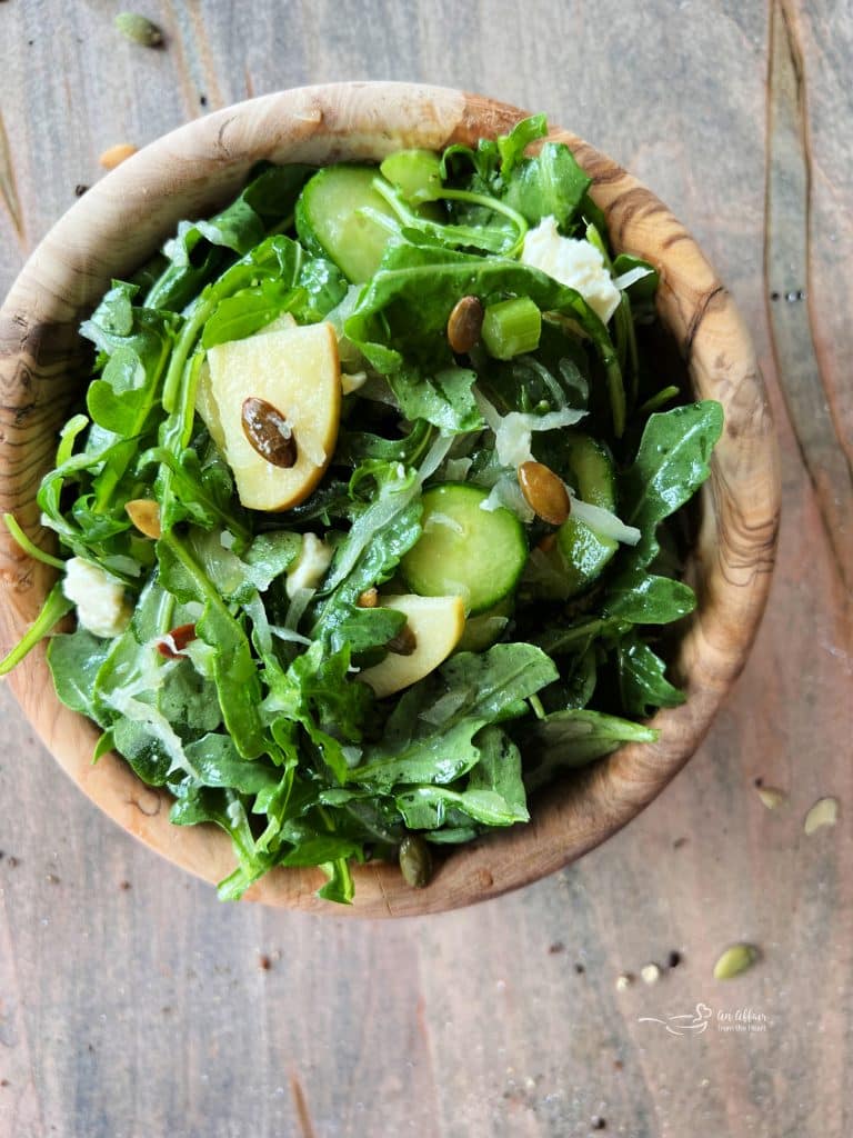 TikTok Sauerkraut Arugula Salad in a wooden bowl.