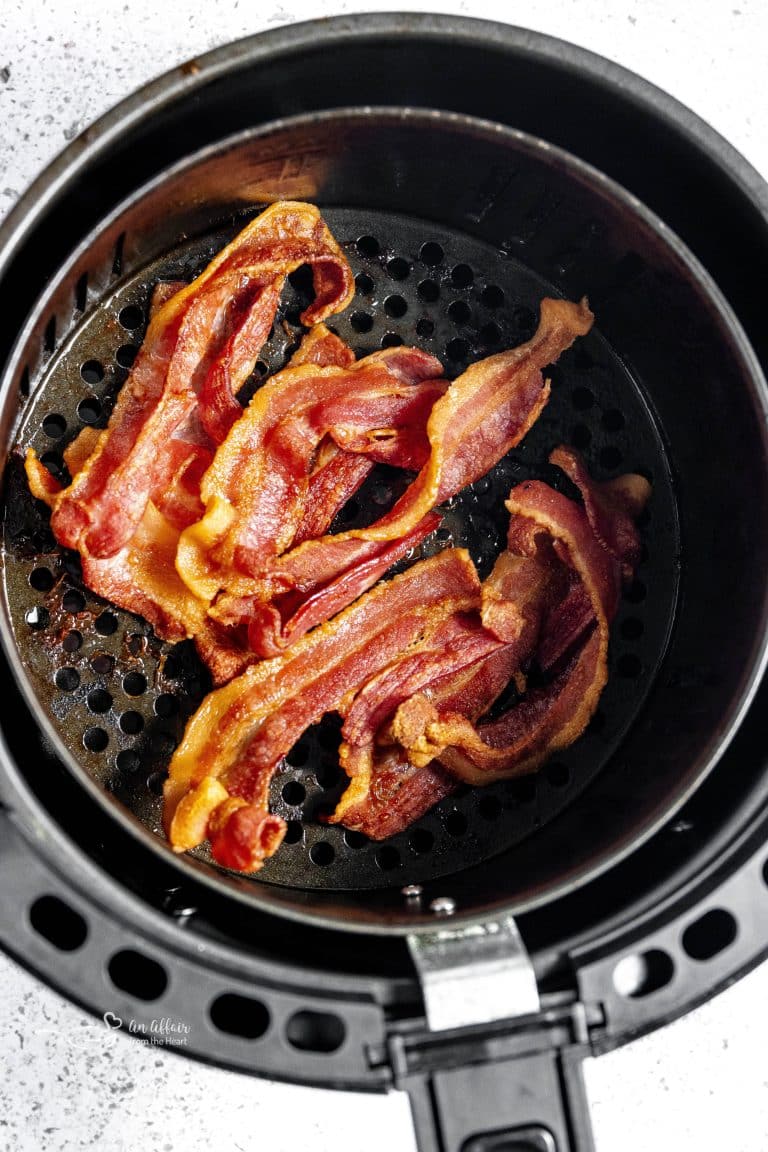 Freshly cooked air fryer bacon in the air fryer basket