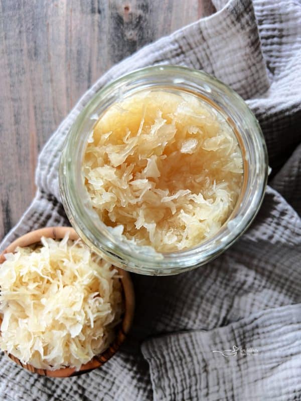 jar of Frank's Kraut and sauerkraut in a wooden bowl