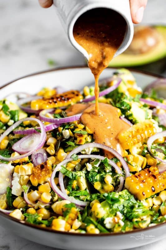 Close up of Grilled Corn and Avocado Salad in a large, white serving bowl.