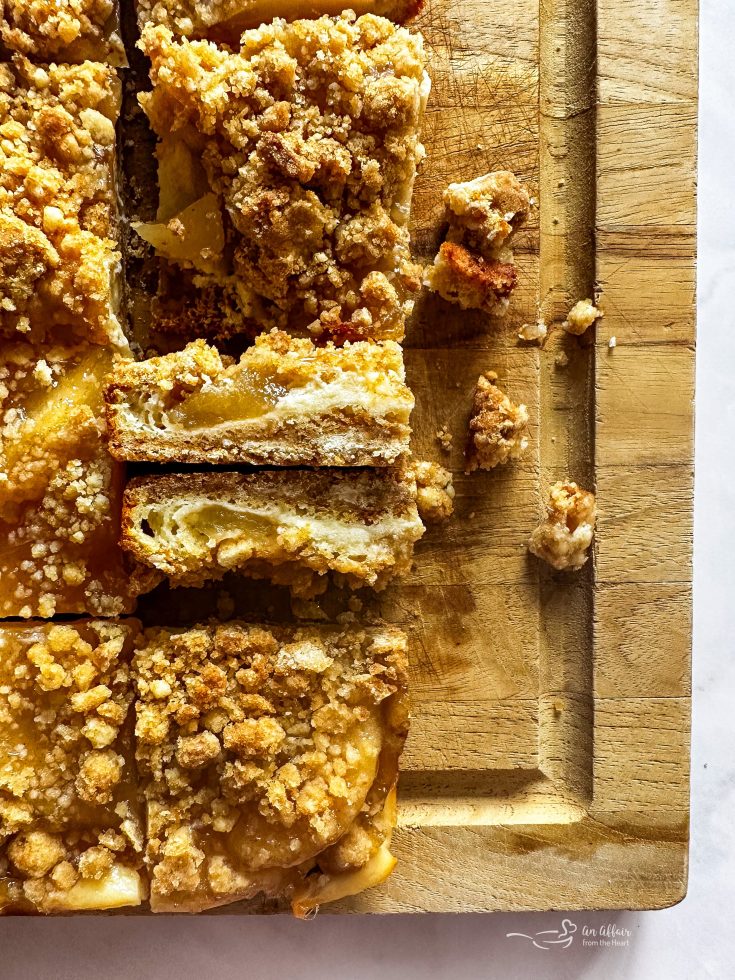 Close up of Apple Pie Crumb Bars on their side so we can see the inside