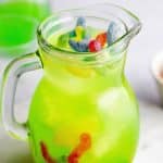 Jug full of Halloween kids punch topped with gummy worms