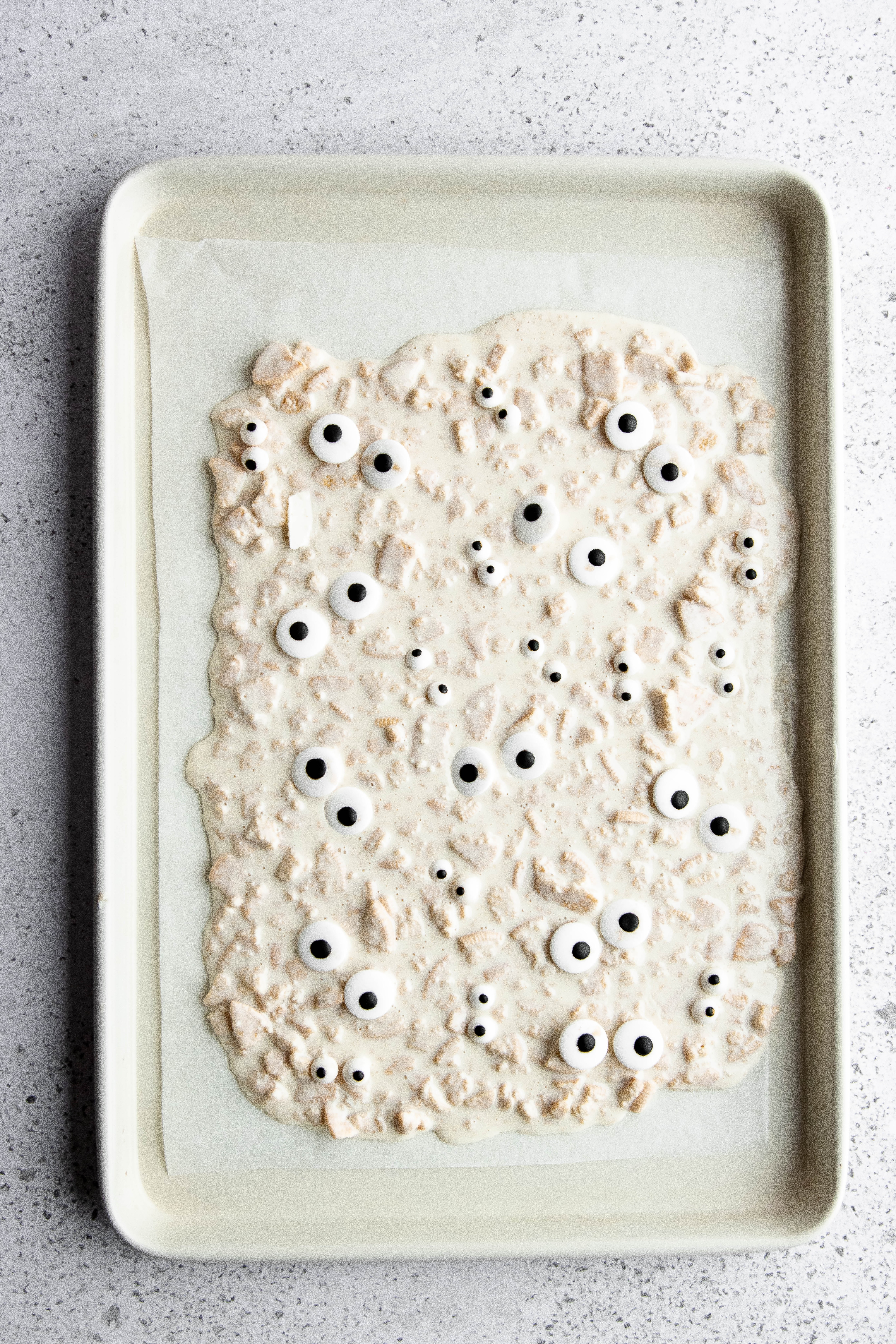 Hauntingly Simple Oreo Mummy Bark 13 Oreo bark mixture spread on parchment paper