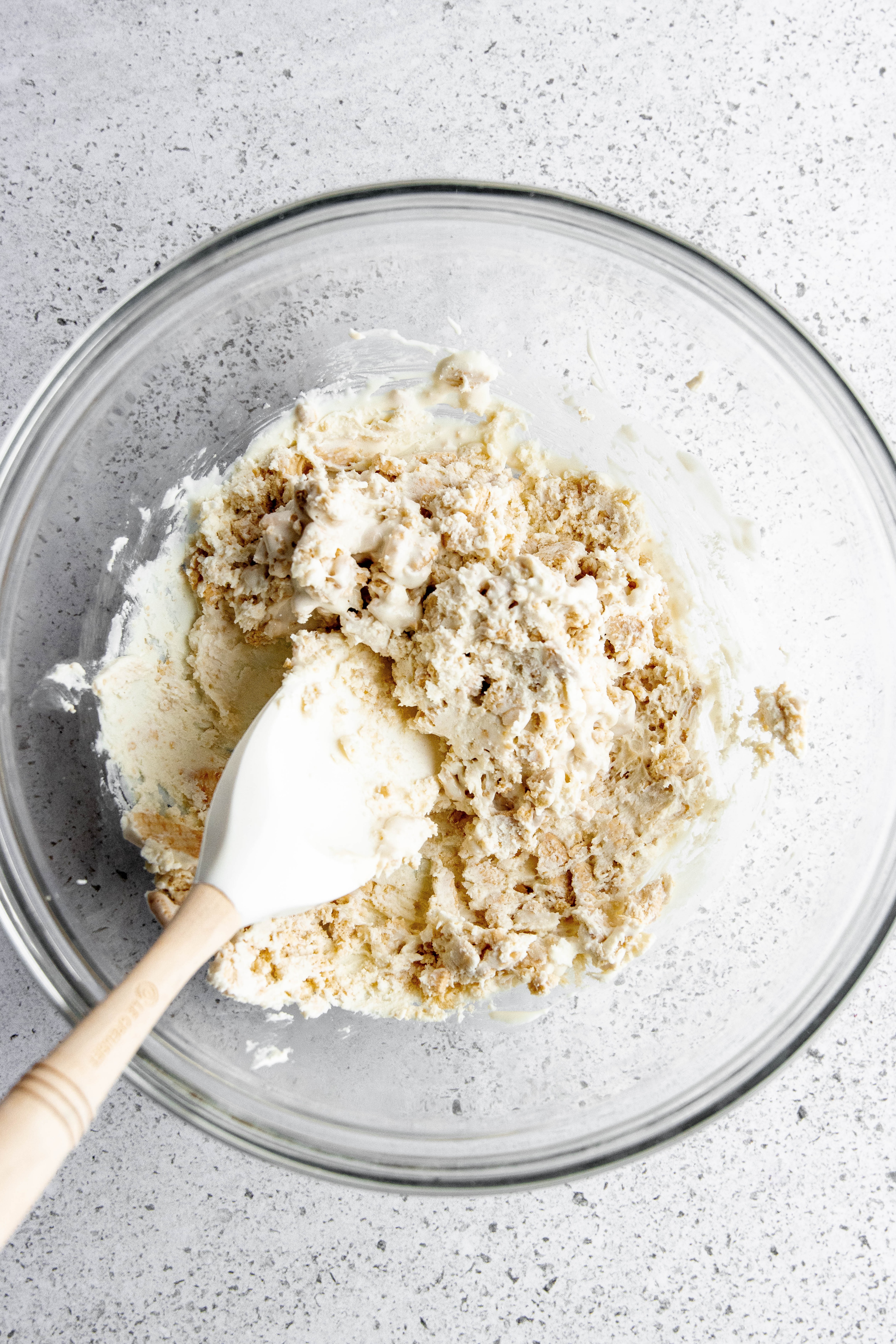 Hauntingly Simple Oreo Mummy Bark 11 Melted chocolate being poured over crushed Oreos