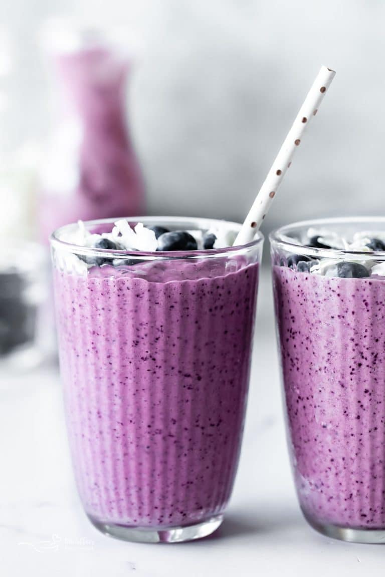 Close up of Blueberry pineapple smoothie with a straw in it