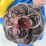 Close up view of Chocolate Banana muffins stacked on a serving plate.