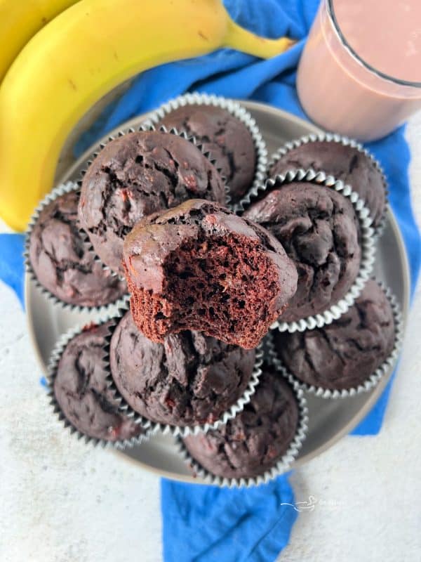 Close up view of Chocolate Banana muffins stacked on a serving plate.