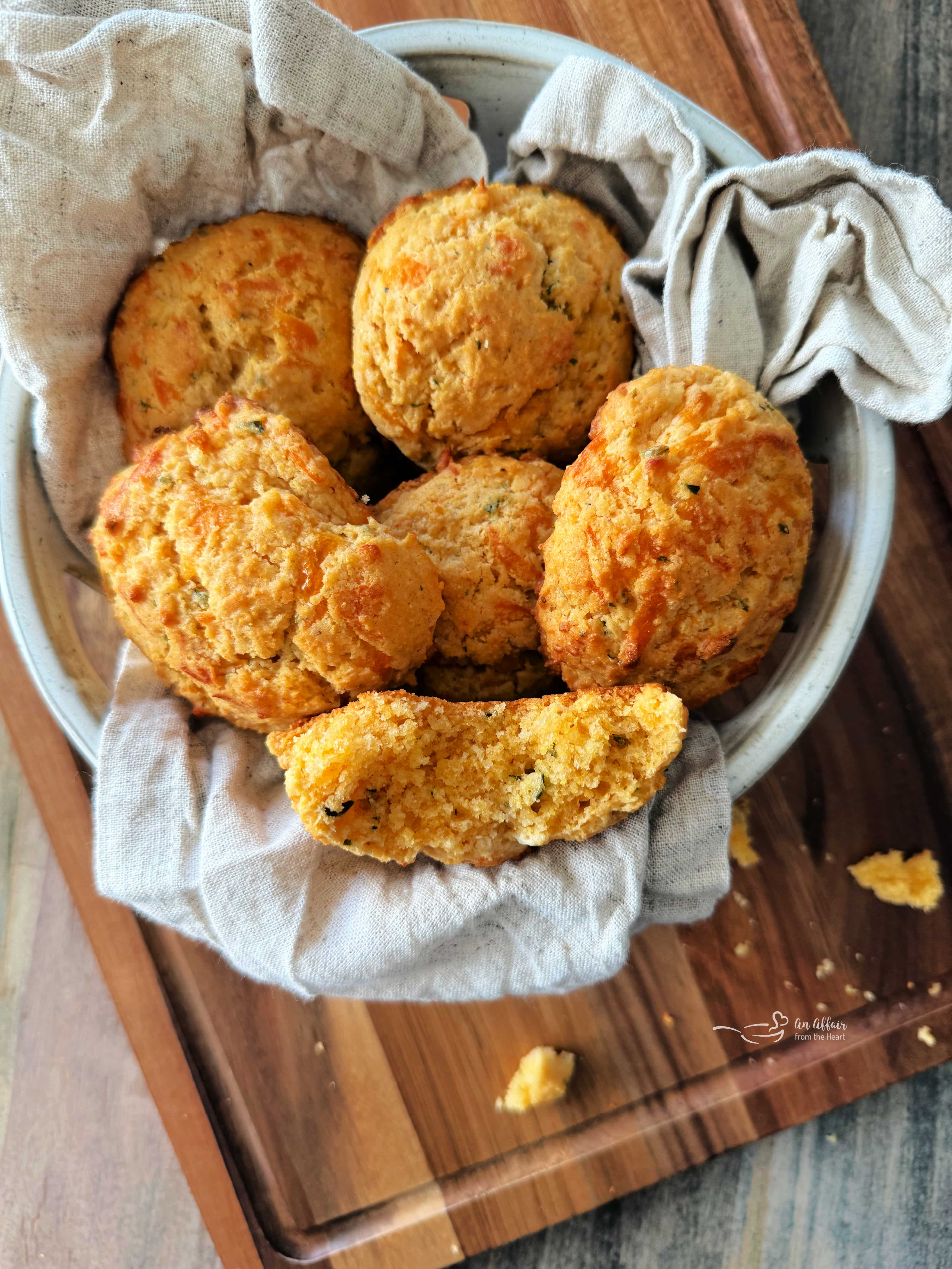 Dorothy's Cornbread Drop biscuits in a basket, one with a bite out of it.