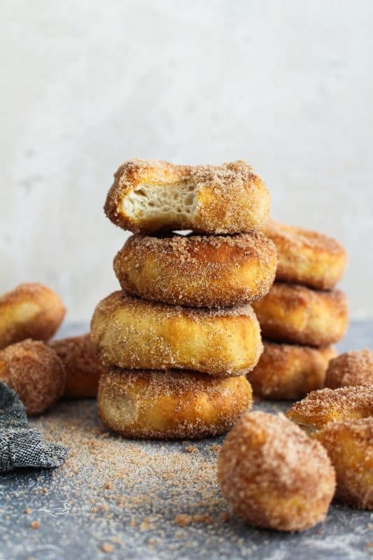 Close up of Air Fryer Biscuit Donuts stacked on a counter.