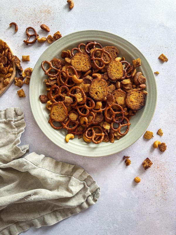 Crockpot Chex Mix in a white bowl.