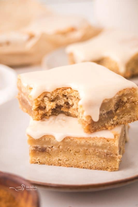 Brown Sugar Cinnamon Pop Tart Bars stacked with a bite out of the top one.