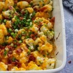 Close up of Loaded Cauliflower Casserole in a white casserole dish.