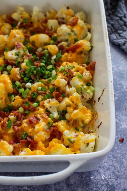 Close up of Loaded Cauliflower Casserole in a white casserole dish.