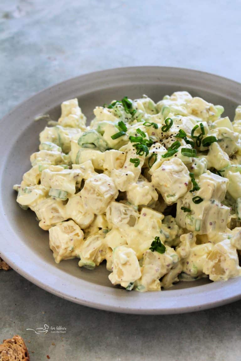 Close up of Deviled Egg Potato Salad on a grey plate.